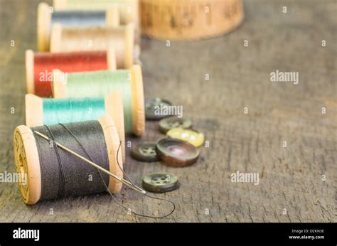 Sewing Thread On Spools With Needle And Buttons Stock Photo Alamy