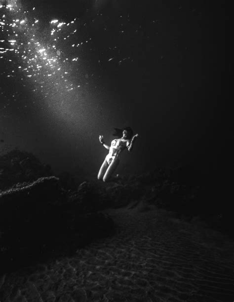 Grayscale Photo Of Woman Swimming Underwater · Free Stock Photo