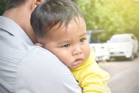Close Up Portrait Of Sad Little Boy Hugging Hugging Father Around