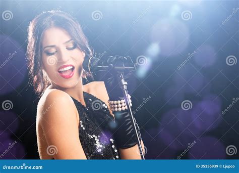 Beautiful Woman During A Concert Holding A Microphone Stock Image