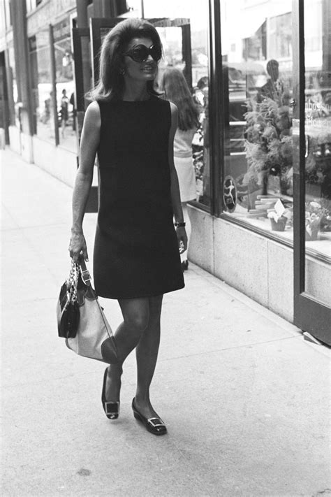 jacqueline kennedy onassis wearing a black dress sunglasses and the gucci “jackie” handbag in