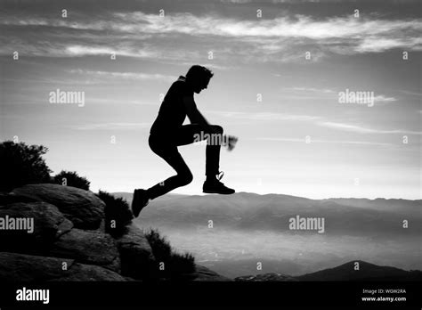 Man Jumping From Cliff Black And White Stock Photos And Images Alamy