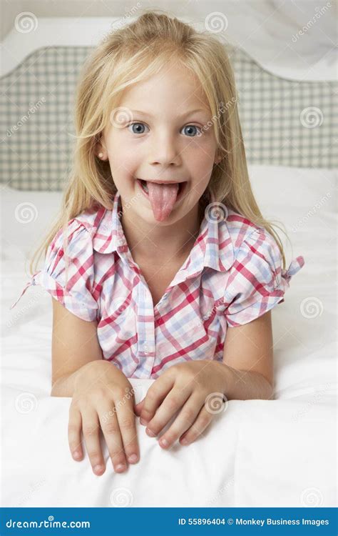 Young Girl Lying On Bed Pulling Funny Face Stock Photo Image Of Home