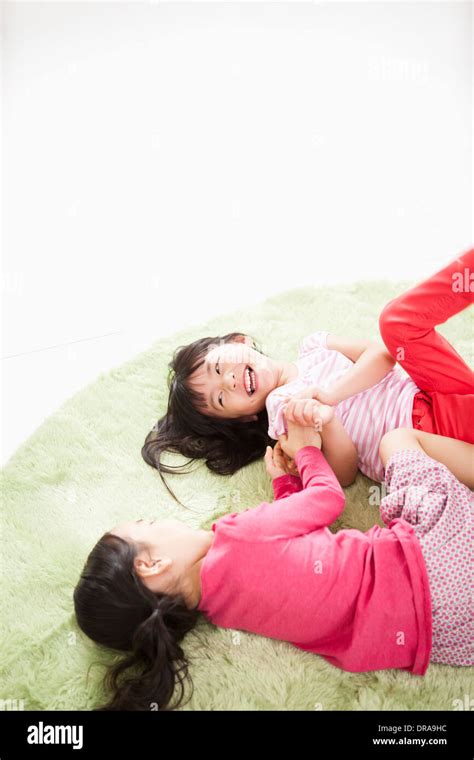 Kids Lying On A Carpet Playing Stock Photo Alamy