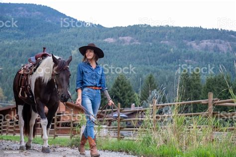Female Rancher Walking With Her Horse Stock Photo Download Image Now