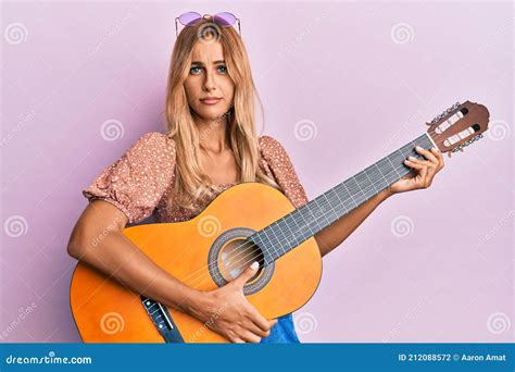 Beautiful Blonde Young Woman Playing Classical Guitar Skeptic And