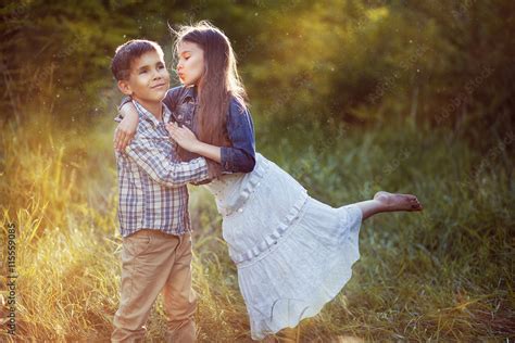 Beautiful Little Girl Kissing A Boy In The Park Foto De Stock Adobe Stock