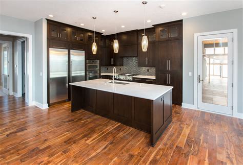 Another great option for wooden kitchenware is olive wood. LOVE this modern look- dark kitchen cabinets, light ...