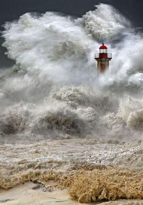 A Huge Ocean Storm Overtakes A Lighthouse In Porto Portugal