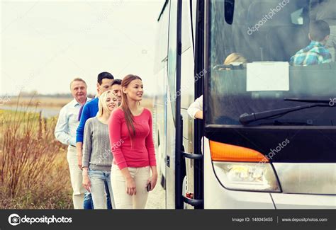 Group Of Happy Passengers Boarding Travel Bus Stock Photo By ©syda