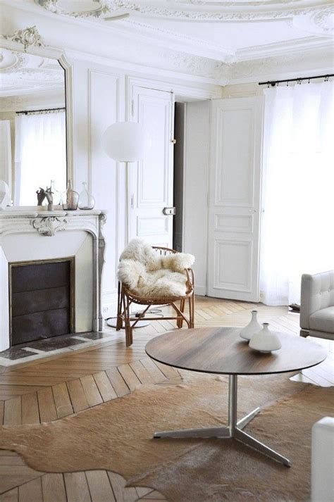 Parisian Living Room With Cowhide Rug Rattan Chair And Brown Round