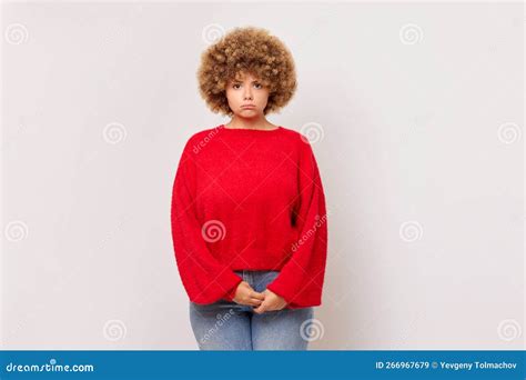 Horizontal Shot Of Displeased Upset Curly Haired Woman In Red Pullover