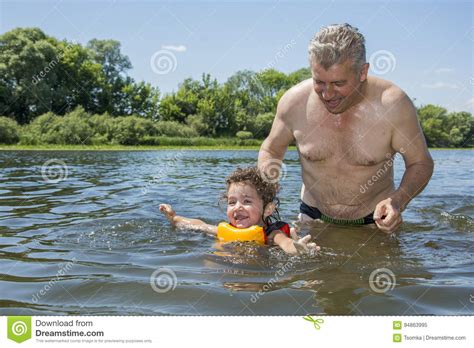 In Summer On A Bright Sunny Day On The River Grandfather Teaches Her