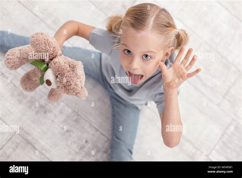 Funny irresistible girl showing tongue Stock Photo - Alamy