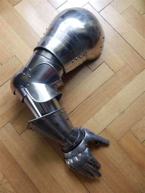 A Knight S Armor And Glove Laying On The Floor With One Hand Extended Out