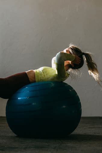 Unrecognizable Fitness Woman Lying On The Pilates Ball In Gym Stock