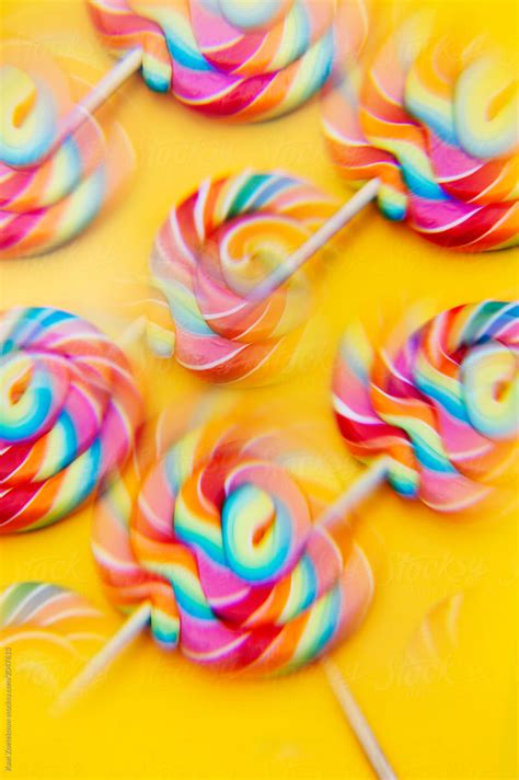 Close Up Of Rainbow Lollipop Candies On Yellow By Stocksy Contributor