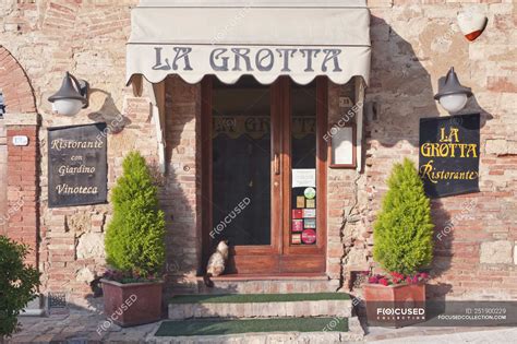 La Grotta Restaurant Entrance With Sitting Cat In Montepulciano