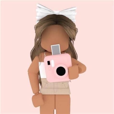 A Doll With A Camera In Her Hands Is Standing On A Pink And White