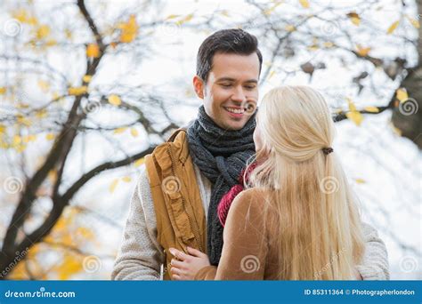 Young Man Looking At Woman In Park During Autumn Stock Photo Image Of
