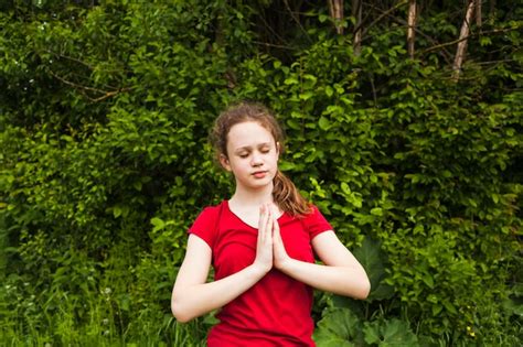 Free Photo Attractive Girl Child Praying With Closed Eyes In Nature