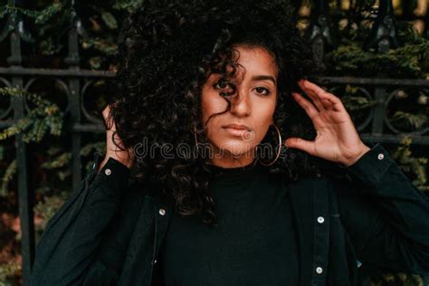 Portrait Of Charming Young African Woman With Curly Hair Street Style