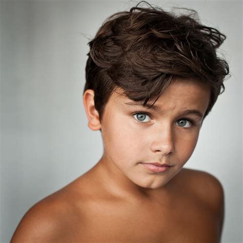 Close Up Boy With Tanned Skin And Blue Eyes Photo By Benedicte Brocard