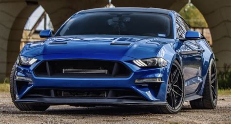 The Front End Of A Blue Ford Mustang