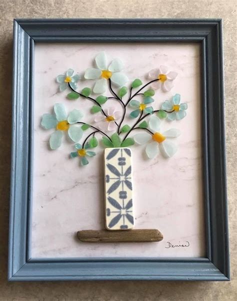 A Vase With Flowers In It Sitting Inside Of A Frame