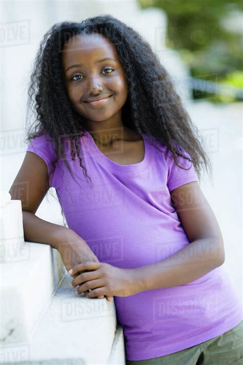 Smiling Black Girl Leaning On Wall Stock Photo Dissolve