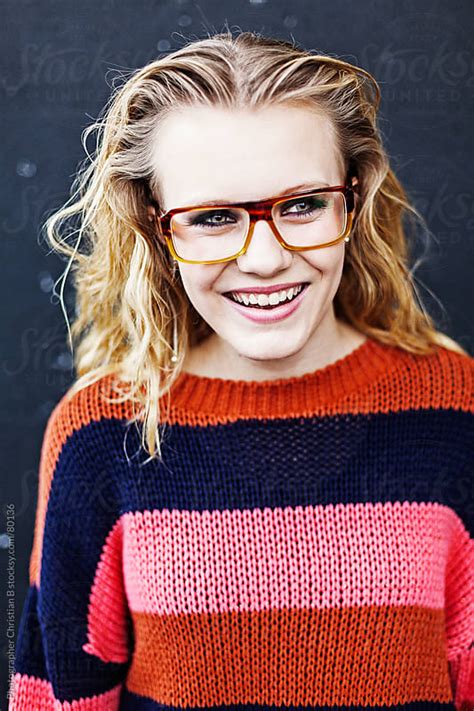 Young Girl With Glasses Laughing By Photographer Christian B Stocksy