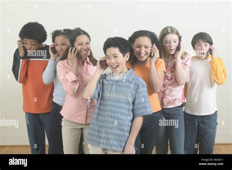 Seven Teenagers Talking On Mobile Phones Stock Photo Alamy