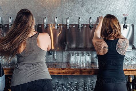 Female Bartenders Pouring Craft Beer On Tap By Gabriel Gabi Bucataru