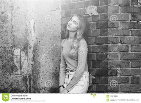 Stylish Girl Near Brick Textured Wall Beauty And Fashion Stock Photo