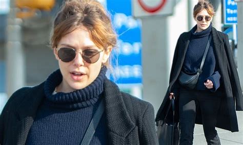 Elizabeth Olsen Is The Epitome Of Style As She Drapes A Coat Over A
