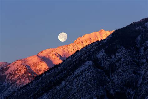 A Full Moon Over A Snow Covered Photograph By Todd Korol