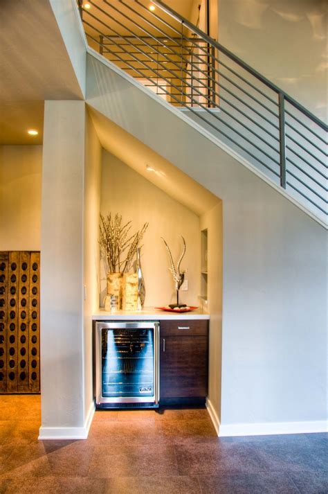 With its strong, geometric shape and functional importance, a masterful staircase can serve as the centerpiece of a building. Great use of space under stair well. This mini bar has a simple, contemporary design. | Bar ...