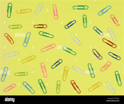 A Group Of Multi Colored Paper Clips Spread Out On A Yellow Background