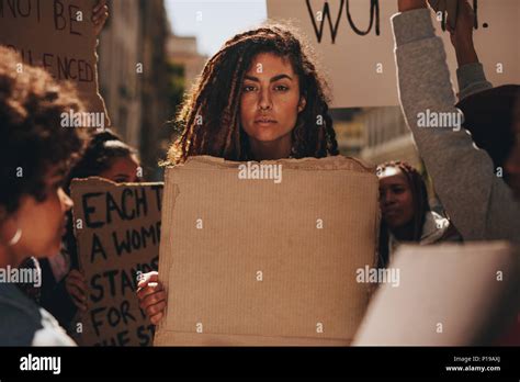 Serious Woman Holding A Blank Placard During A Protest Outdoors Group