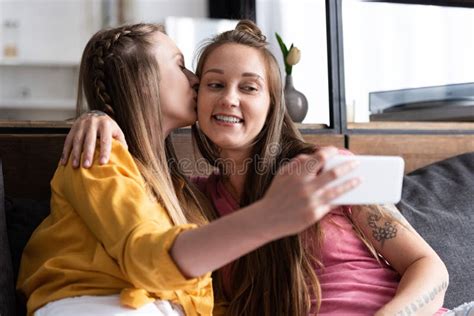 Lesbian In Yellow Blouse Kissing Girlfriend While Taking Selfie Stock Photo Image Of Bisexual