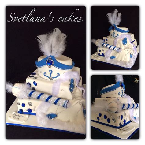 Three Tier White Blue And Silver Sunnet Cake With Draped Cape Hat And