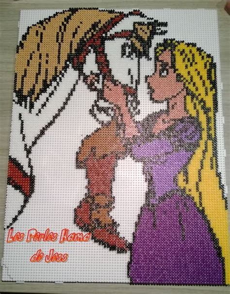A Cross Stitch Picture Of Two People Kissing Each Other
