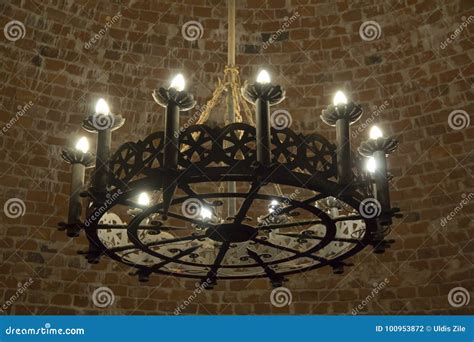 An Ancient Middle Ages Chandelier On A Brick Castle Ceiling Stock Photo