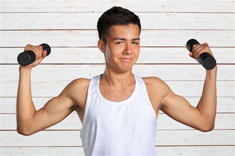 Premium Photo Funny Weak Man Tries To Lift A Weight