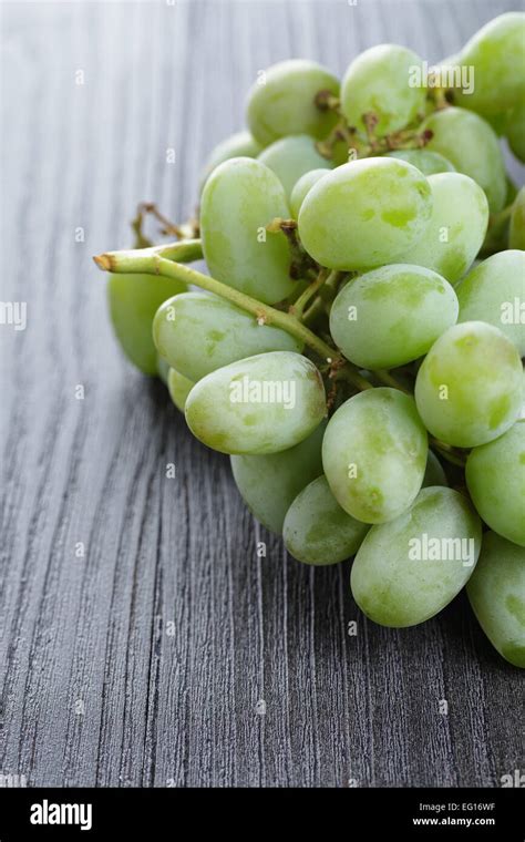 Ripe Green Grapes On Black Wood Table Stock Photo Alamy