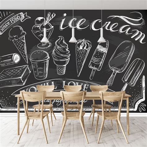 A Chalkboard Wall With Ice Cream Drawn On It And Wooden Chairs Around