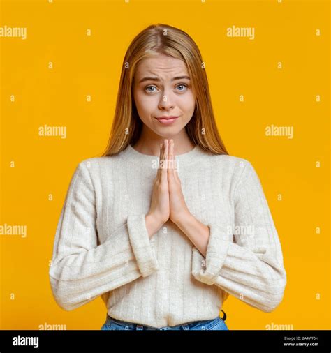 Beautiful Millennial Girl Praying With Hands Clasped Near Face Stock