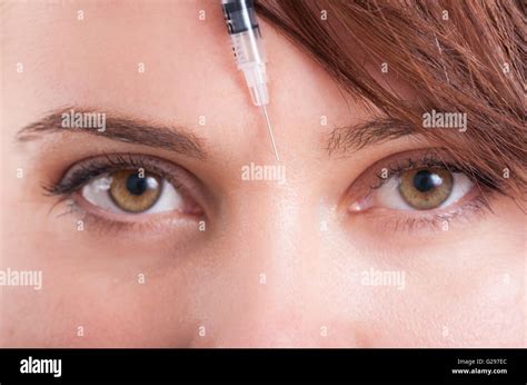 Botox Syringe Needle Between Eyes On Forehead Closeup View Stock Photo