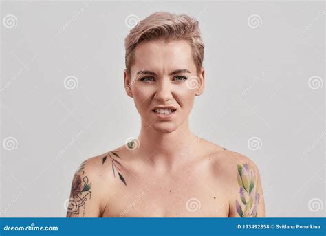 Ewww Portrait Of Arrogant Half Naked Tattooed Woman With Pierced Nose And Short Hair Frowning
