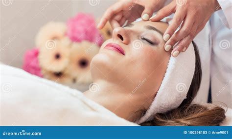 Beautiful Woman Relaxing During Rejuvenating Facial Massage In A Stock Image Image Of